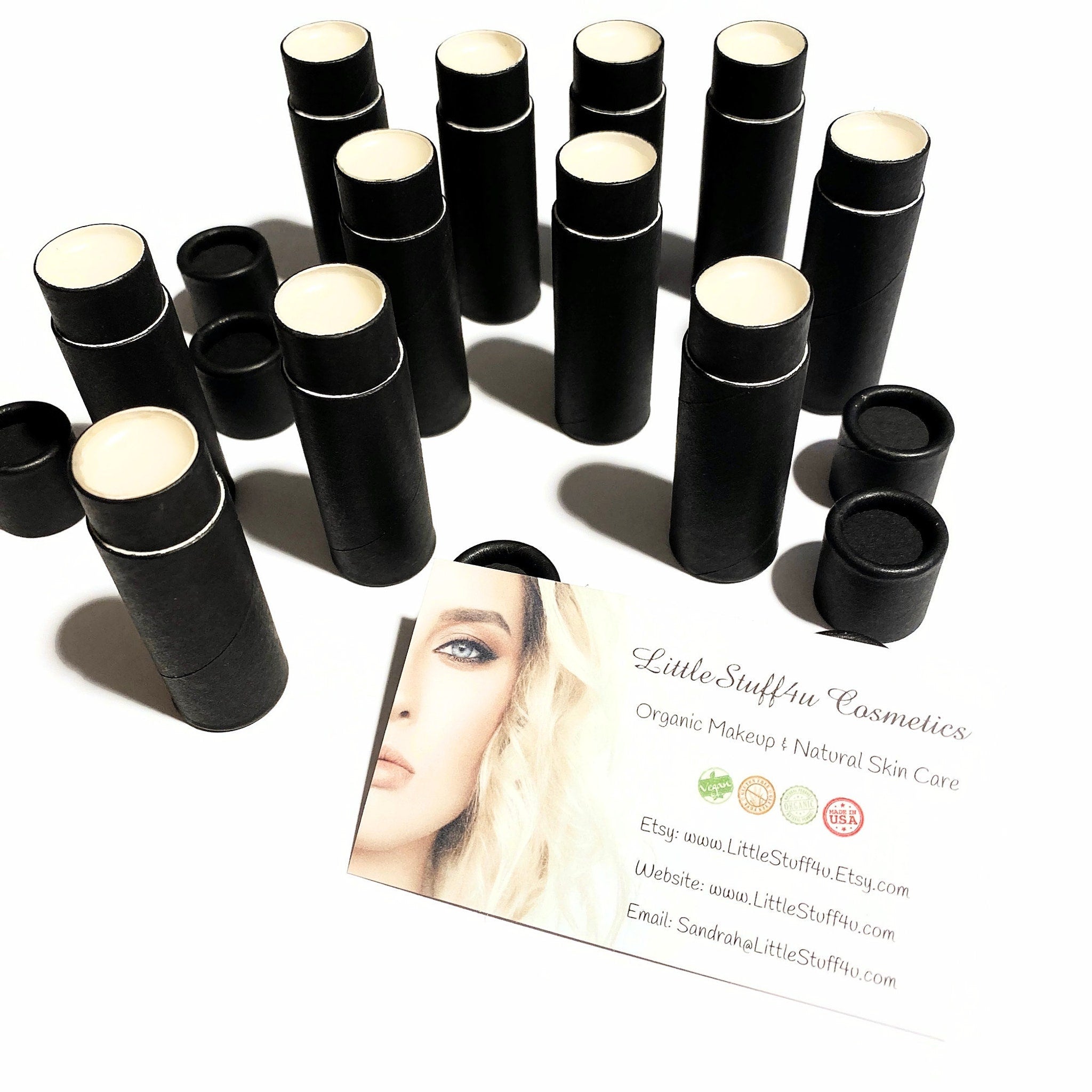 Lip balm tubes, black cardboard, white lip surface, Little Stuff4u Cosmetics branding visible, natural skin care product