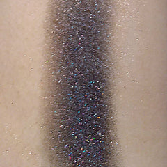 Close-up of Queen of Damn Near Everything Eyeshadow palette showing rich, pigmented powder textures in vibrant jewel tones