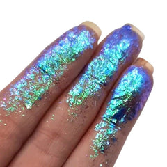 Side view of Prism Chromaflake Eyeshadow Flakes showing iridescent multicolor flakes in sleek black compact