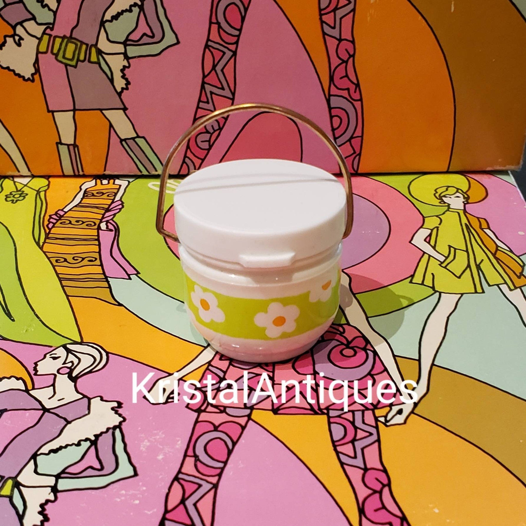 Eye makeup container with white lid, gold handle, and floral pattern on green band, Yardley brand