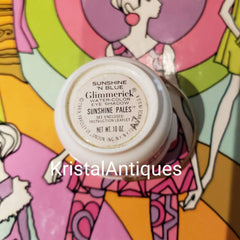 Vintage eye shadow with white container, colorful background, and Glimmerick text visible