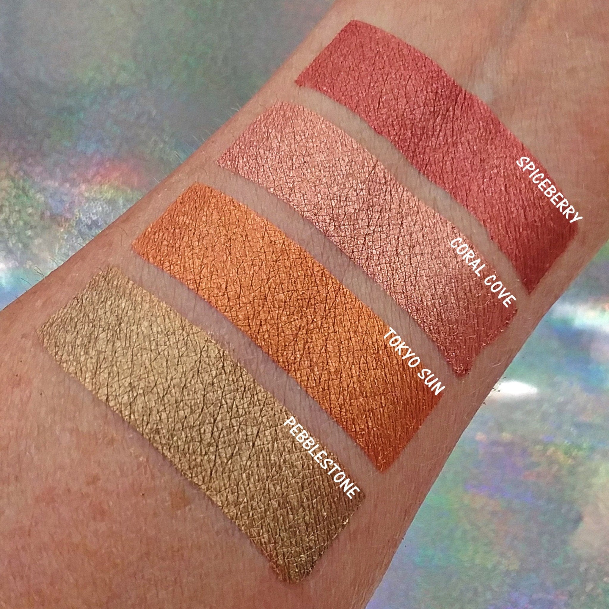 Side view of pressed mineral eyeshadow in coppery red spiceberry shade with metallic finish