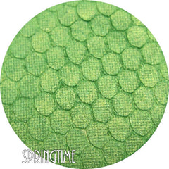 Pressed mineral eyeshadow in vibrant spring green shade with smooth matte finish, shown in compact case.