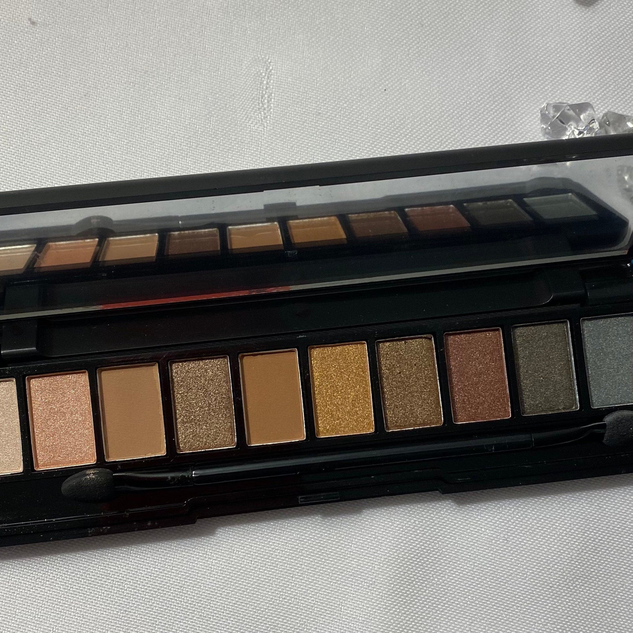 Close-up of matte and shimmery eyeshadow palette showing rich pigmentation in neutral office-appropriate shades