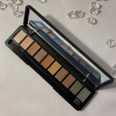 Vegan eyeshadow palette with six matte and shimmer shades in neutral browns and pinks, sleek black compact
