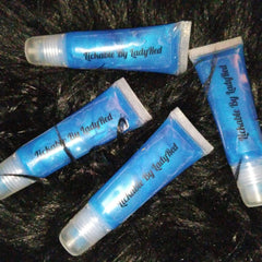 Lip gloss tubes with blue glitter, clear tube, and "Lickable By Lady Red" text on black background