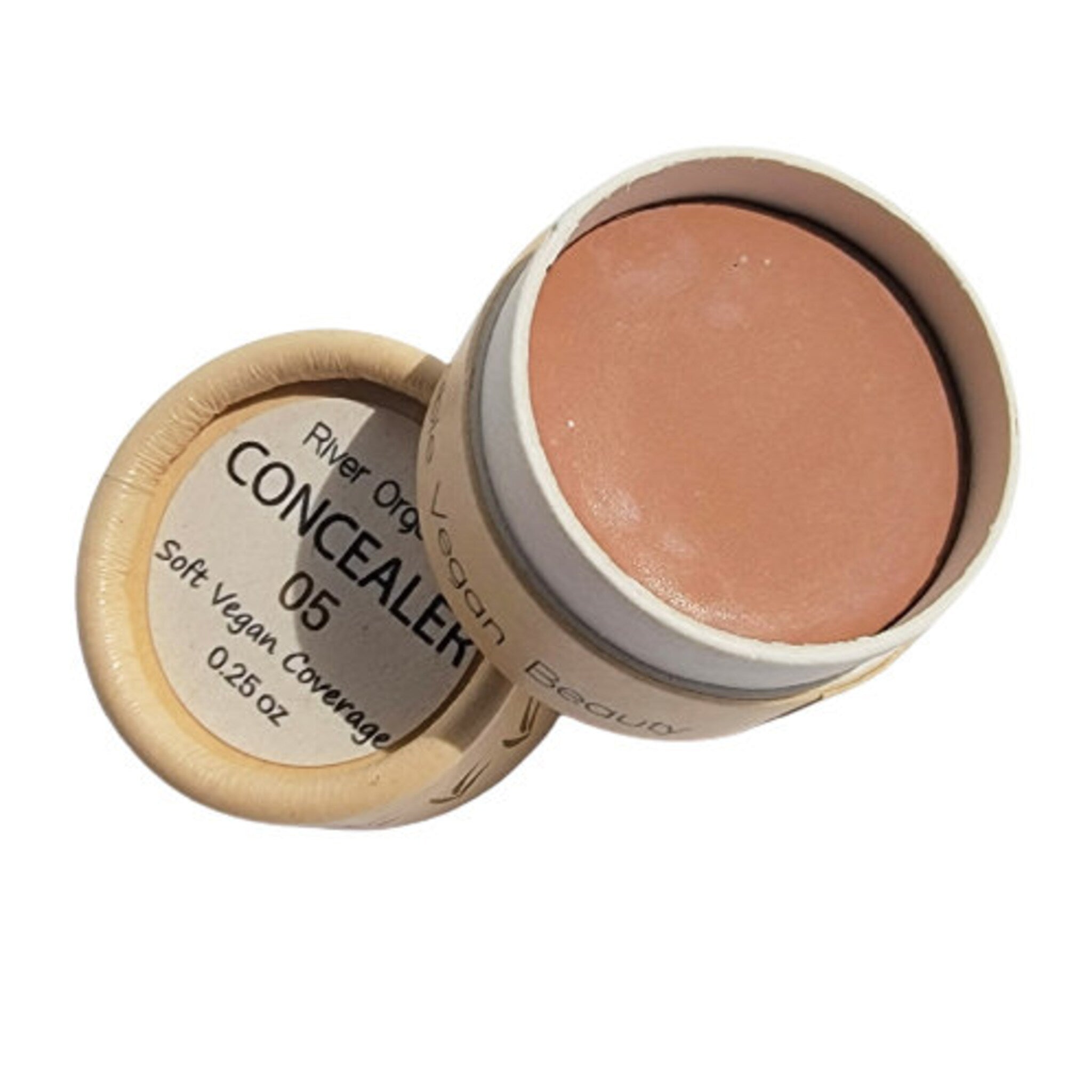 Side view of vegan zero waste concealer pot showing matte beige texture and minimalist bamboo lid design
