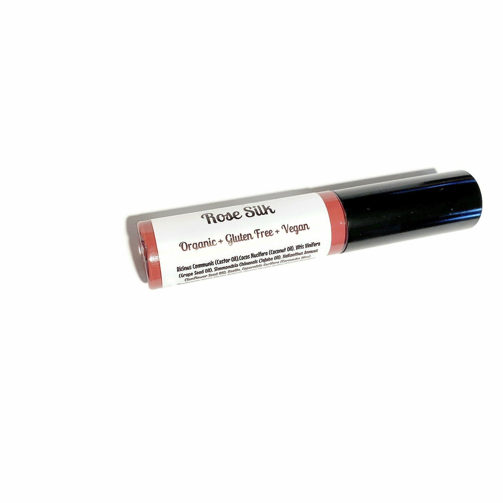 Lipstick tube with red tint, black cap, and Rose Silk label on white background