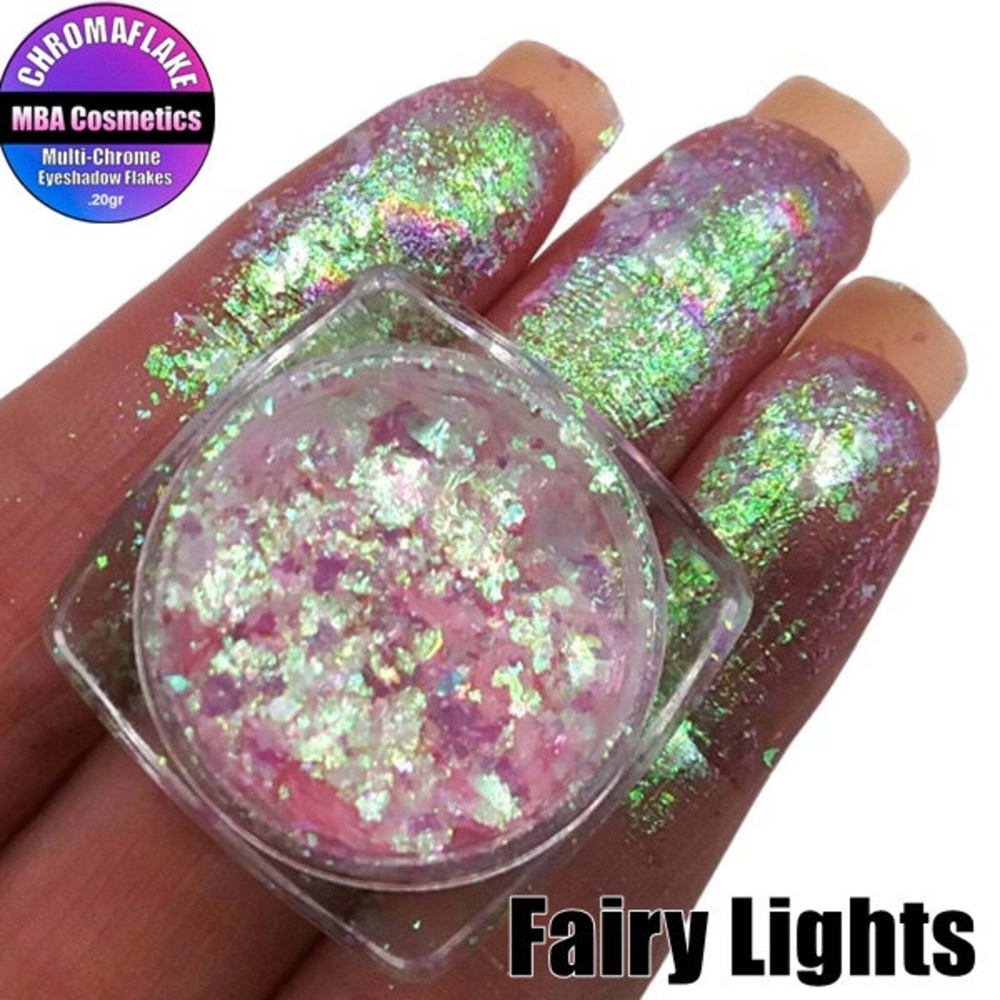 Side view of Fairy Magic Chromaflake Eyeshadow palette showing iridescent purple and teal pressed powders with shimmer flakes