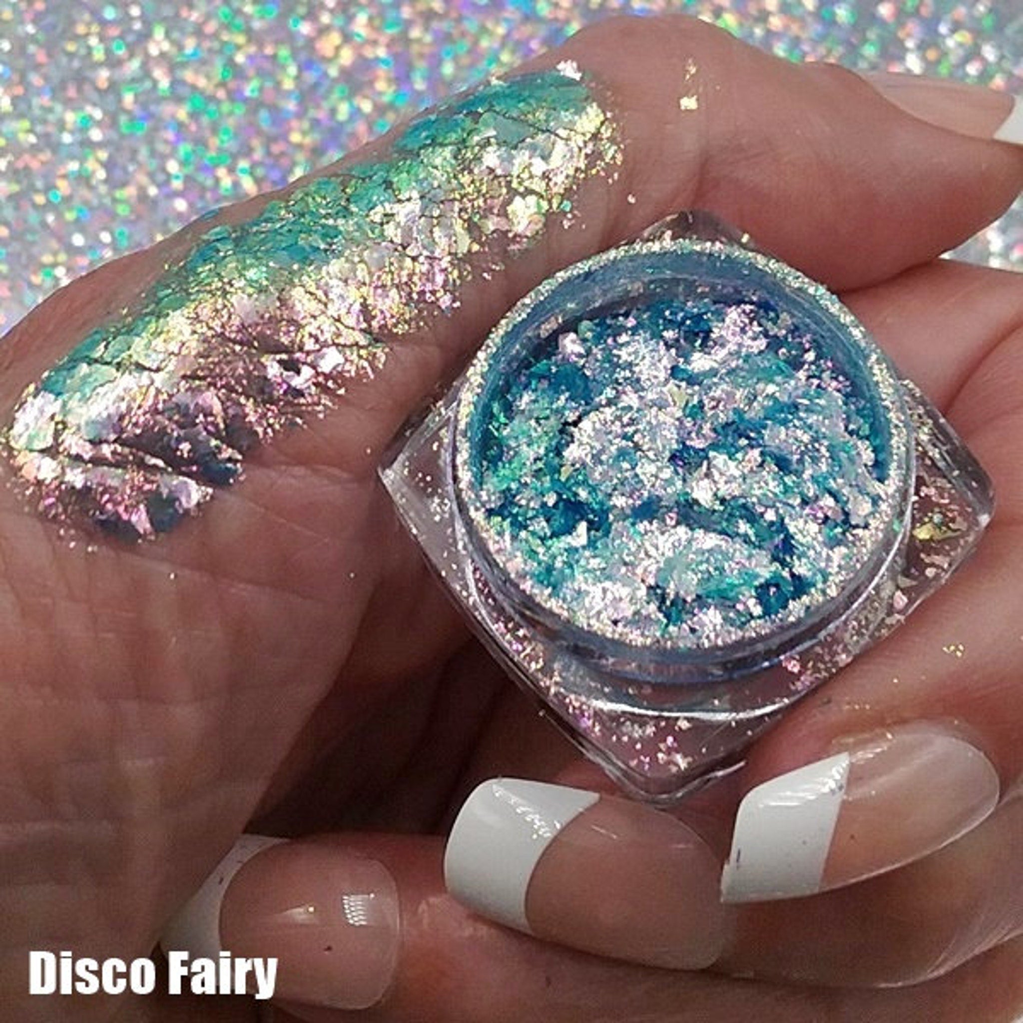 Side view of Fairy Magic Chromaflake Eyeshadow palette showing six iridescent shades in circular pans with holographic packaging