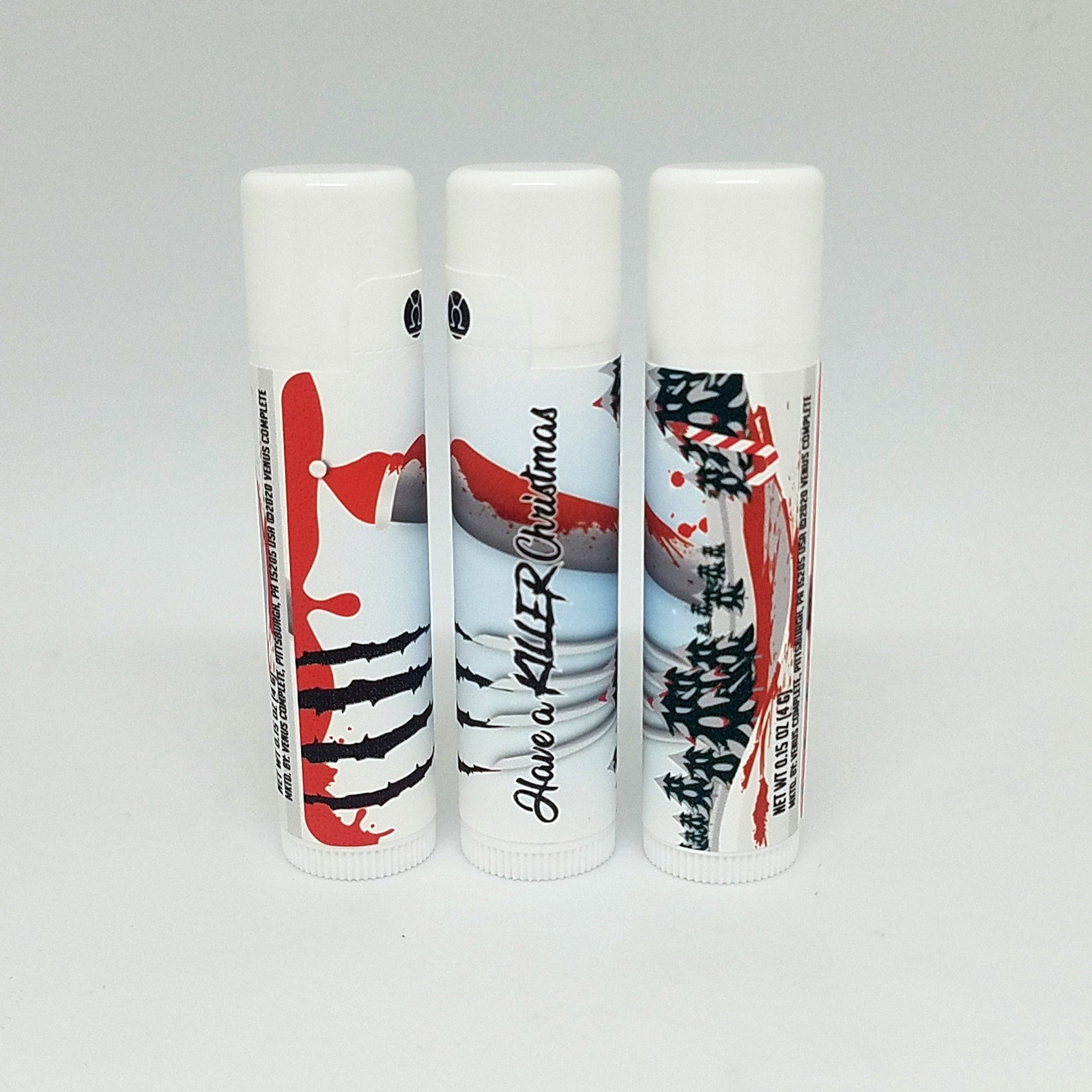 Lip balm tubes with white, red, and black designs, Have a Killer Christmas text, Venus Complete brand