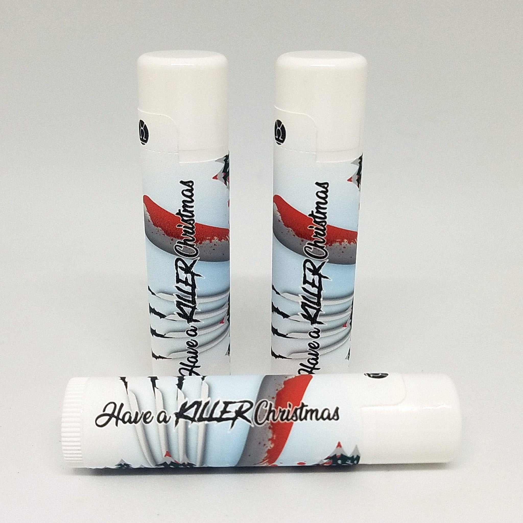 Lip balm tubes with white caps, printed with "Have a KILLER Christmas" design, and red accents