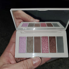 Side view of LOTS Makeup Eye Shadow palette showing gradient shades in warm neutrals with sleek black compact