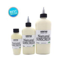 Natural sunscreen bottles, cream-colored liquid, black caps, Veritas Soap Co. branding