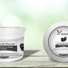 Charcoal face scrub in white jar with black charcoal pieces, KOHA brand visible