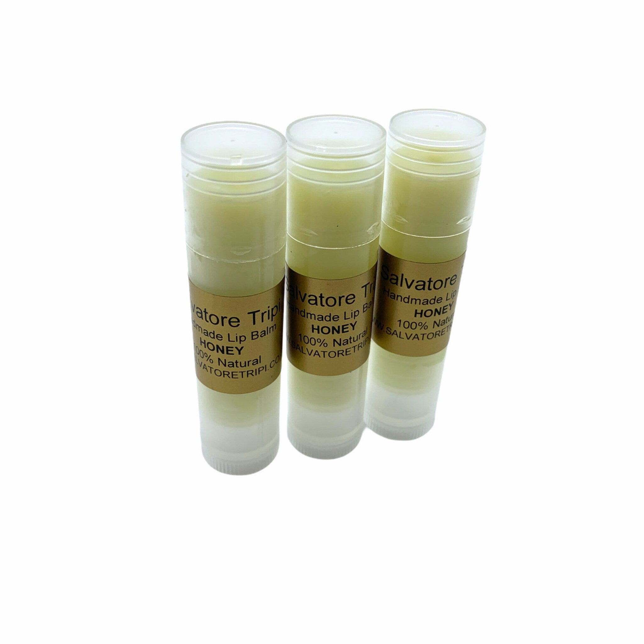 Lip balm tubes with clear plastic casing, light yellow balm, and brand label Salvatore Trip