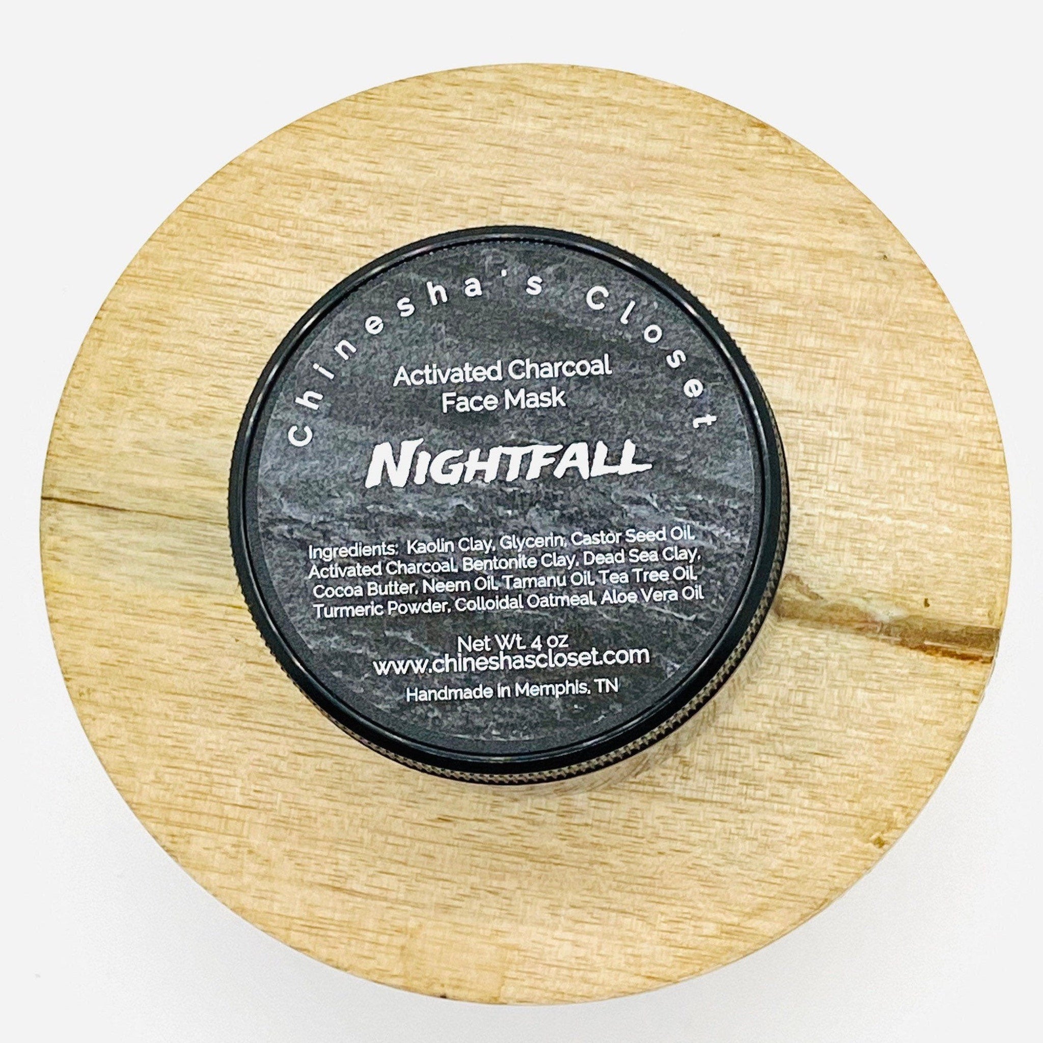 Activated charcoal face mask in black container on light wood surface, Nightfall by Chinesha's Closet