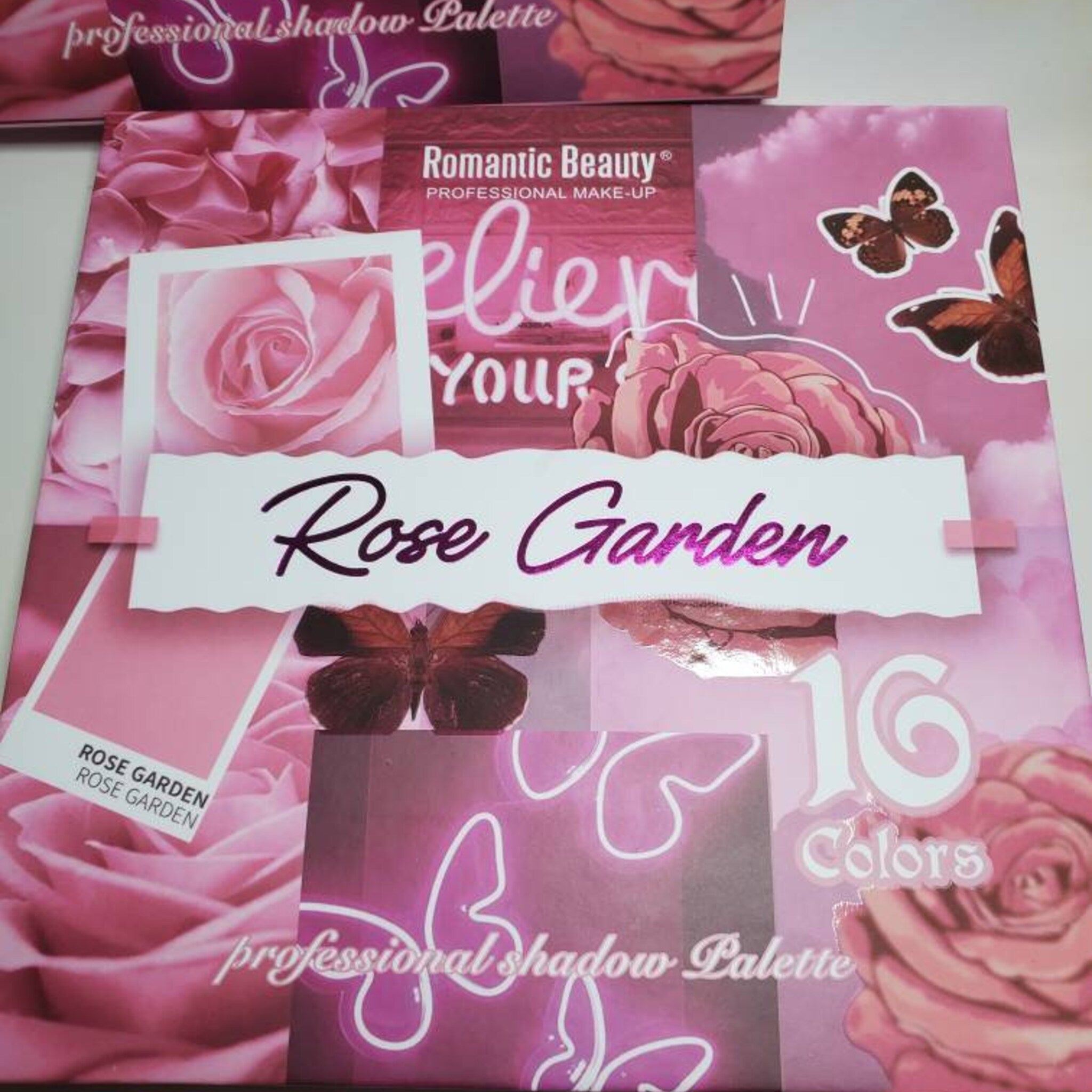 Close-up of Sunflower Rose Garden eyeshadow palette showing bonus dual-ended brush with fluffy and angled tips