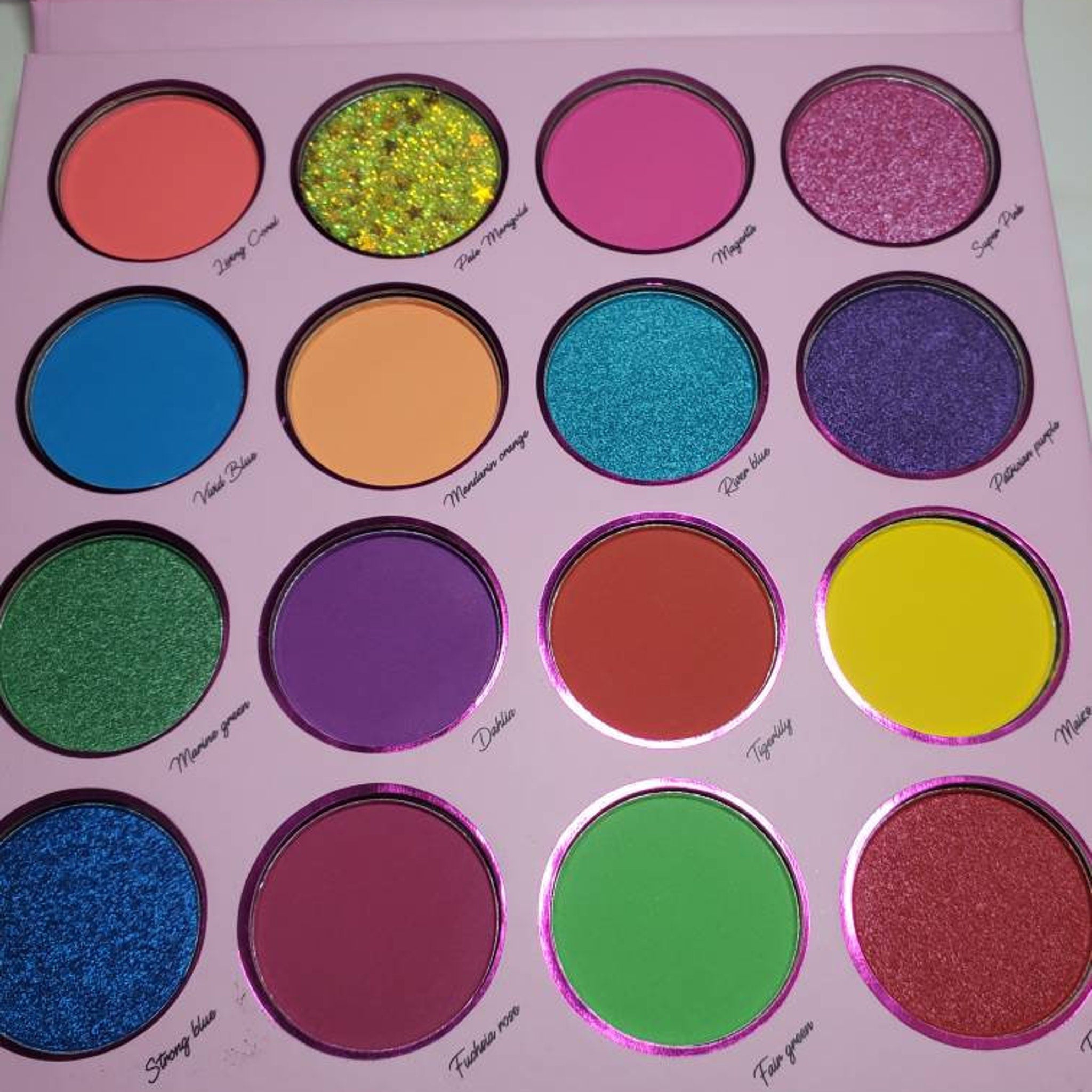 Side view of Sunflower Rose Garden eyeshadow palette showing stacked pans with warm pink and gold shades