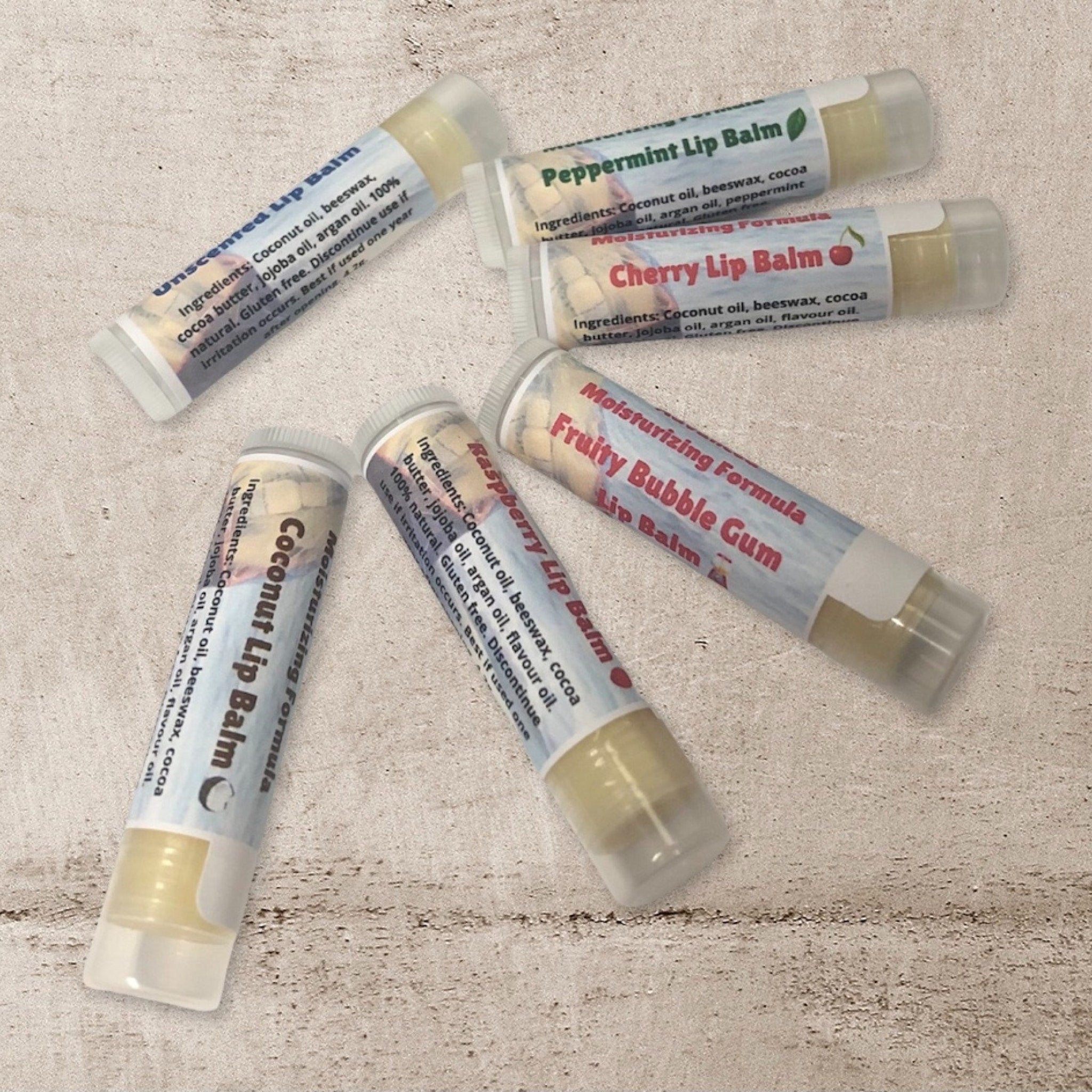 Lip balm tubes with white labels, clear tubes, and Rock Island Naturals text visible