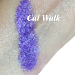 Close-up of violet purple shimmer eyeshadow with sparkling glitter particles in a smokey liner style