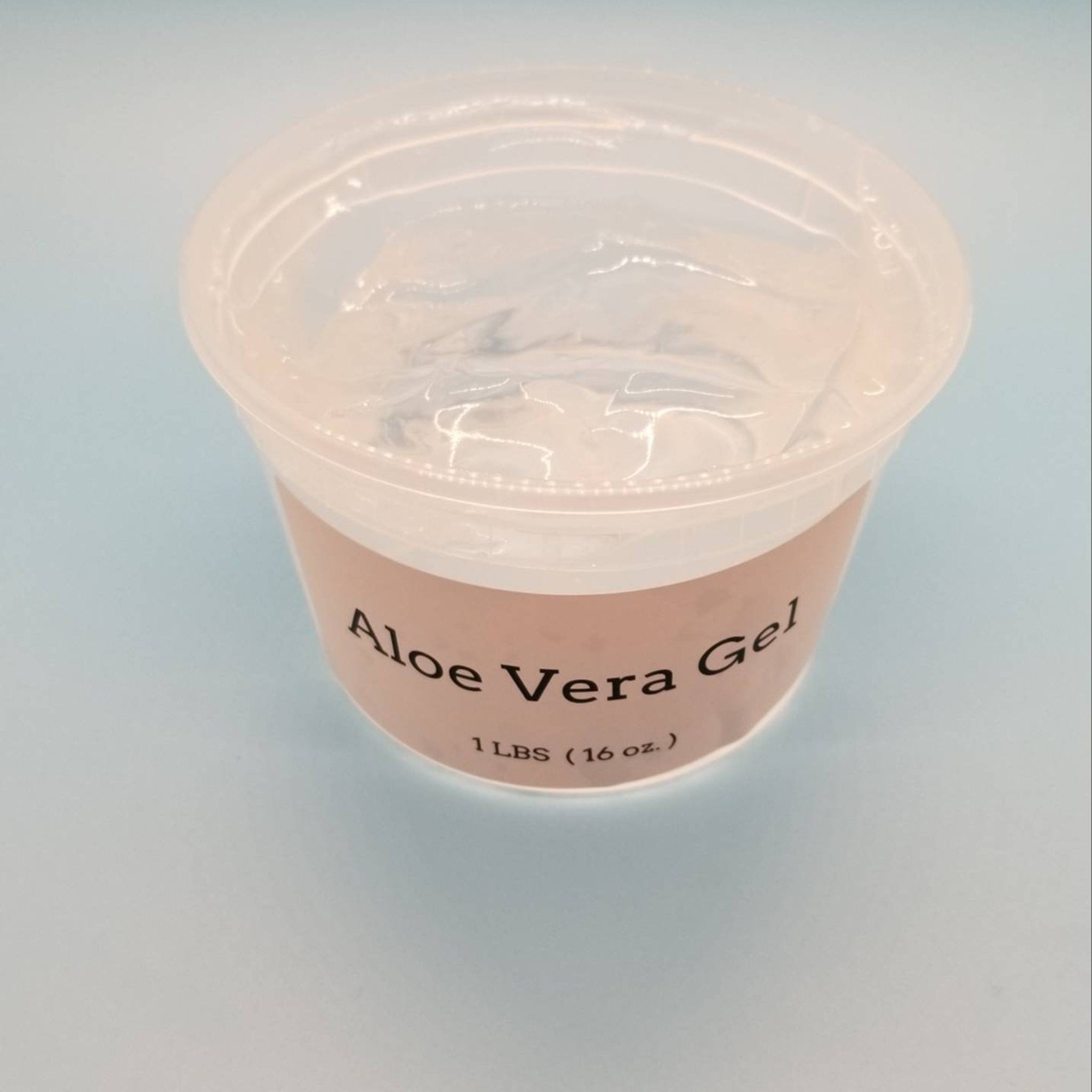Hand applying translucent aloe vera gel to glowing cheek with fingertips