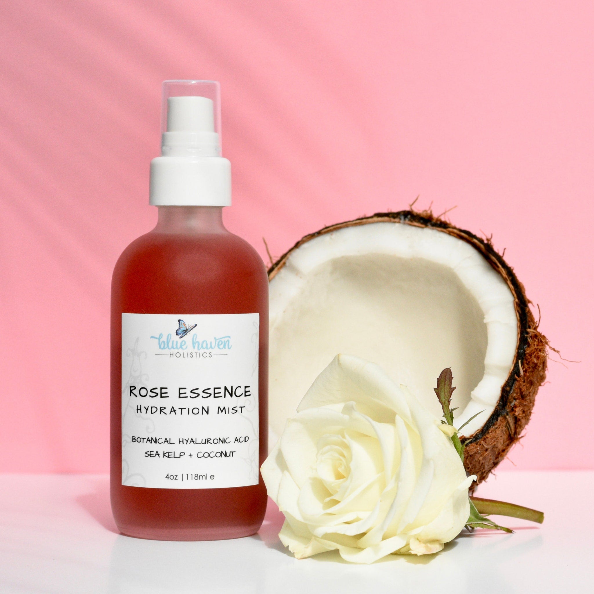 Rose face toner bottle, red liquid, white spray top, Blue Haven Holistics label, coconut and rose