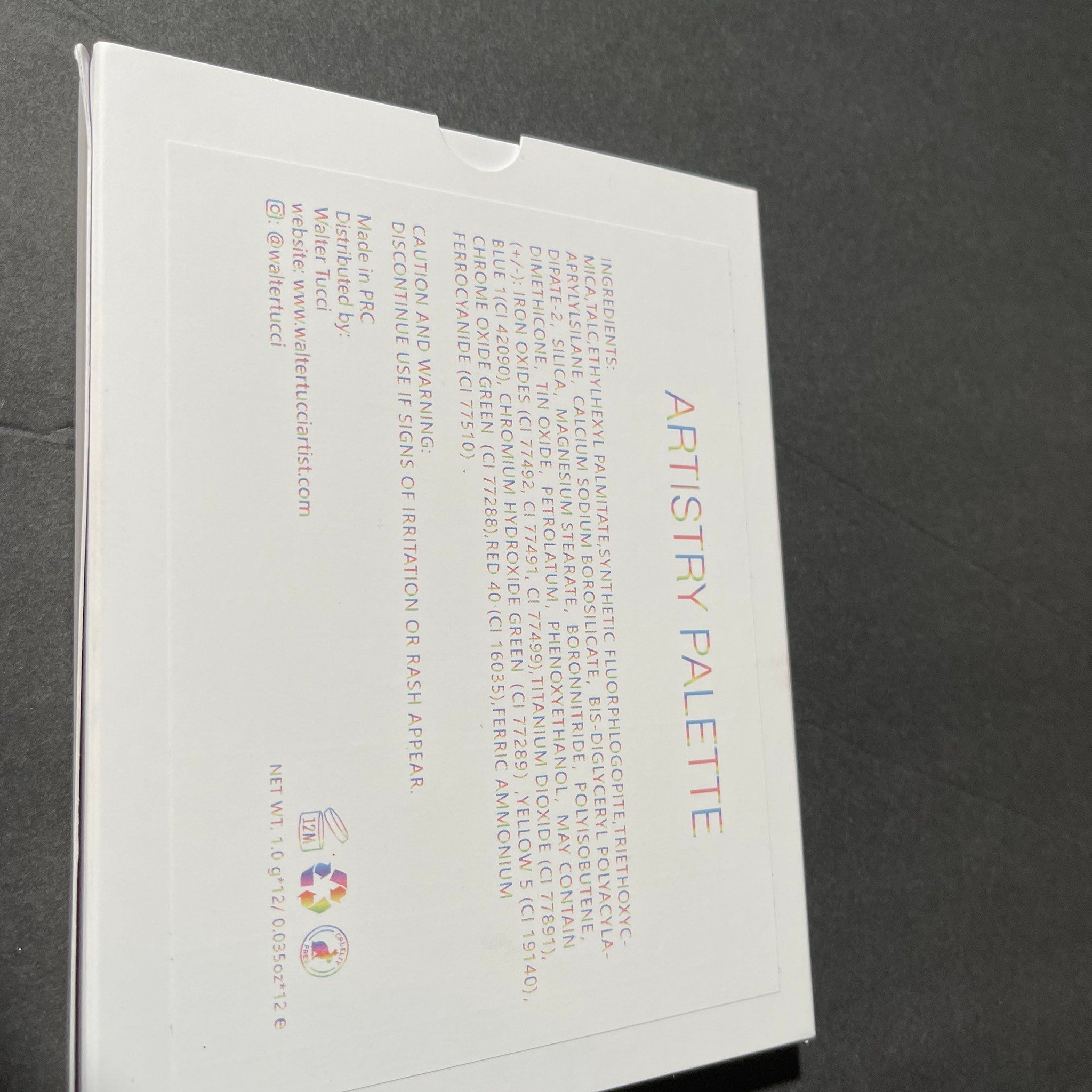 Side view of Walter Tucci Artistry Eyeshadow Palette showcasing shimmering bronze and plum shades in sleek black compact
