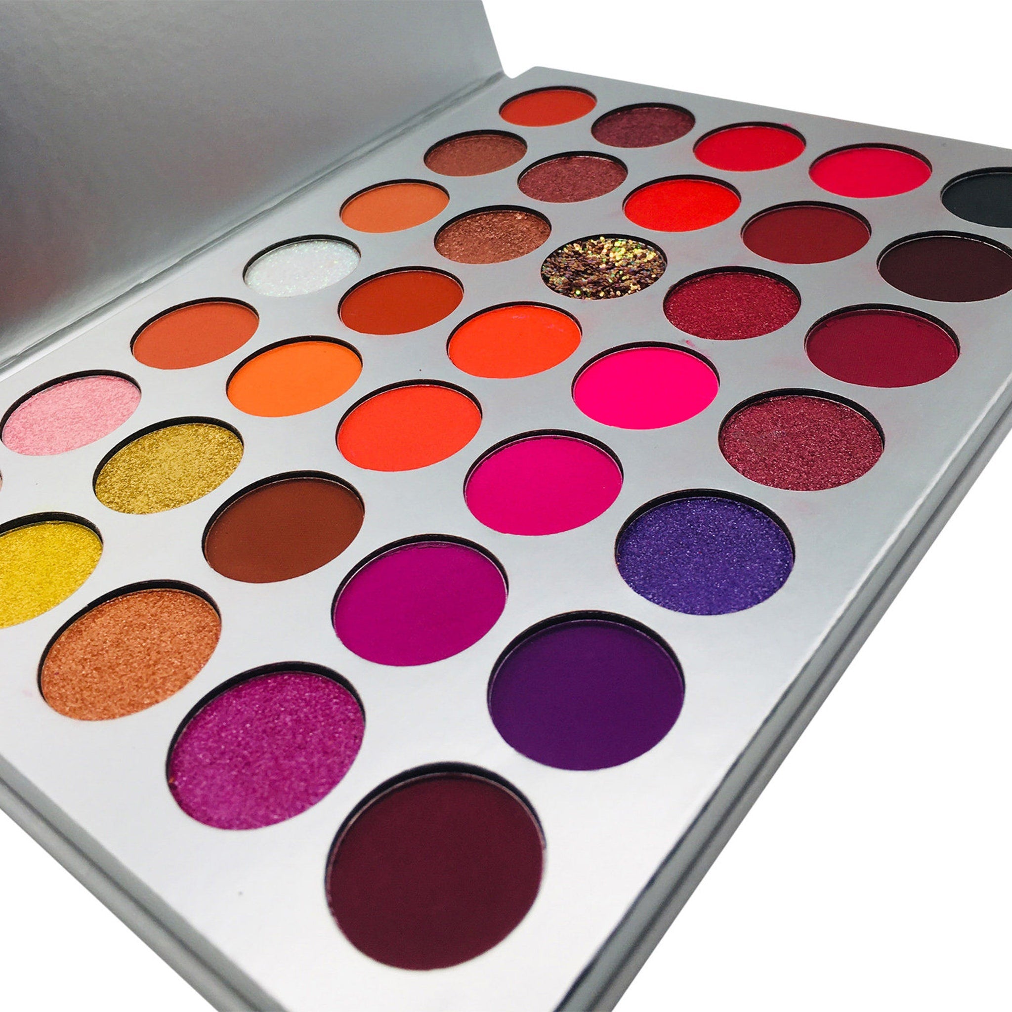 Eyeshadow palette with multiple colors, silver metal case, and round pans
