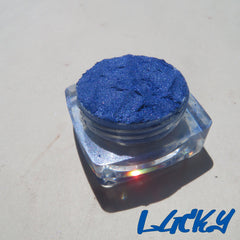 Vibrant bright blue loose mineral eyeshadow with shimmer finish in a round sifter jar