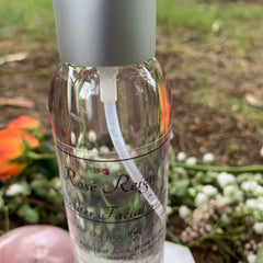 Facial toner bottle with clear glass, silver cap, and "Rose Reign" text label