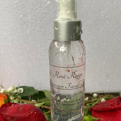 Rosewater facial toner in clear glass bottle with silver cap, Rose Reign label, and water droplets