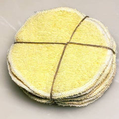 Reusable face pads, yellow terry cloth, white trim, tied with twine