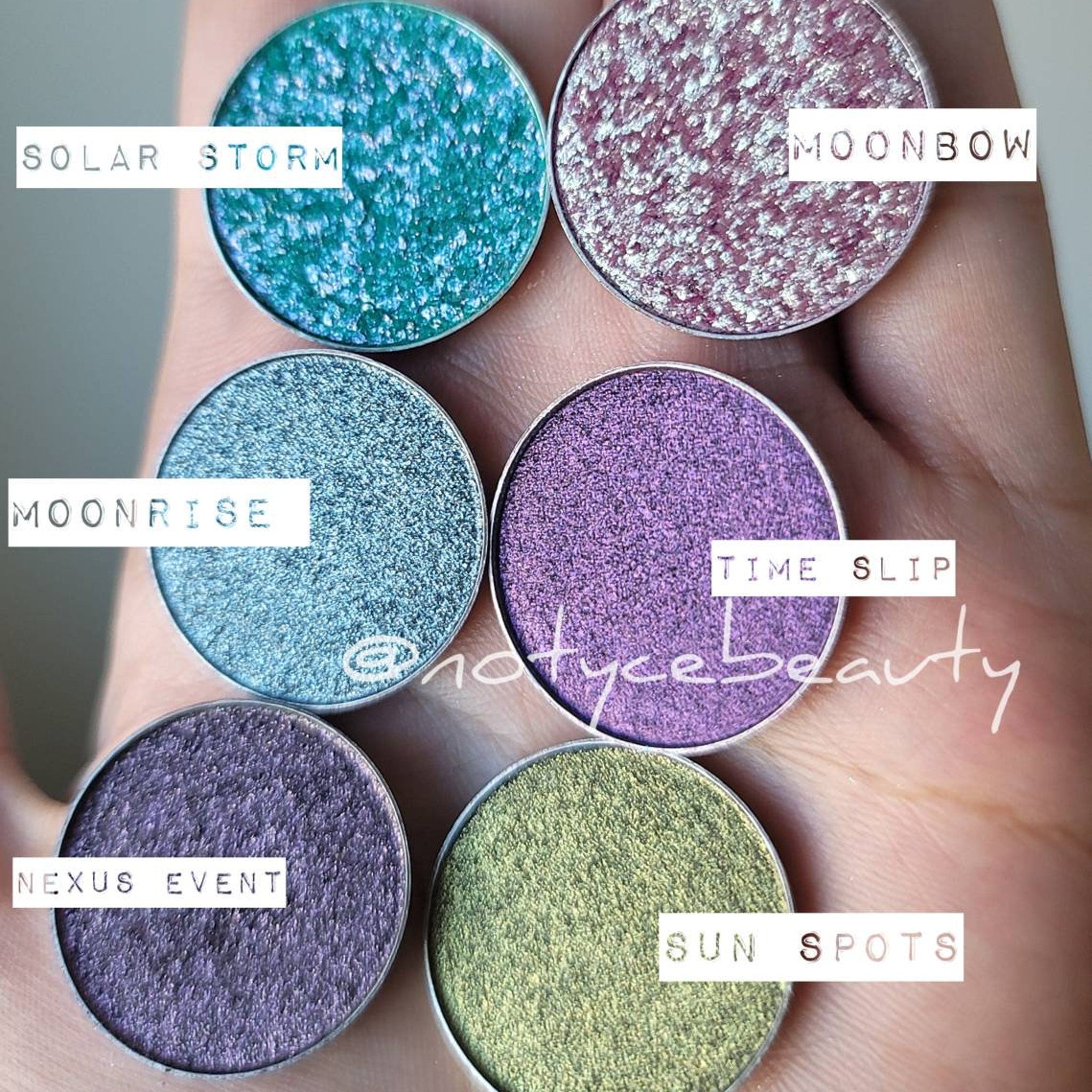 Close-up of Moonrise Chameleon Eye Shadow showing icy blue to grey shift with sparkling shimmer particles