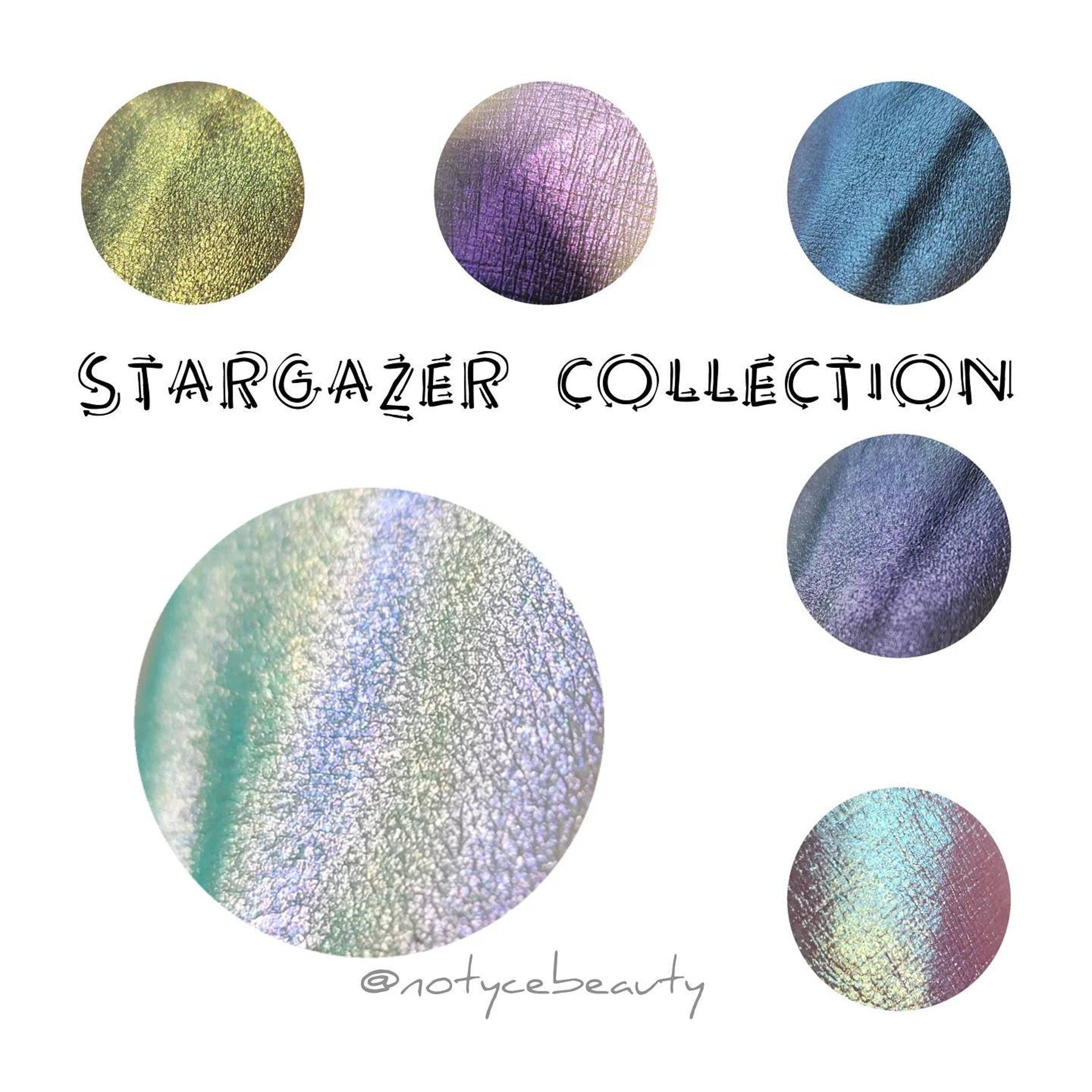 Hand applying icy blue to grey shifting multichrome eyeshadow with sparkling shimmer to eyelid