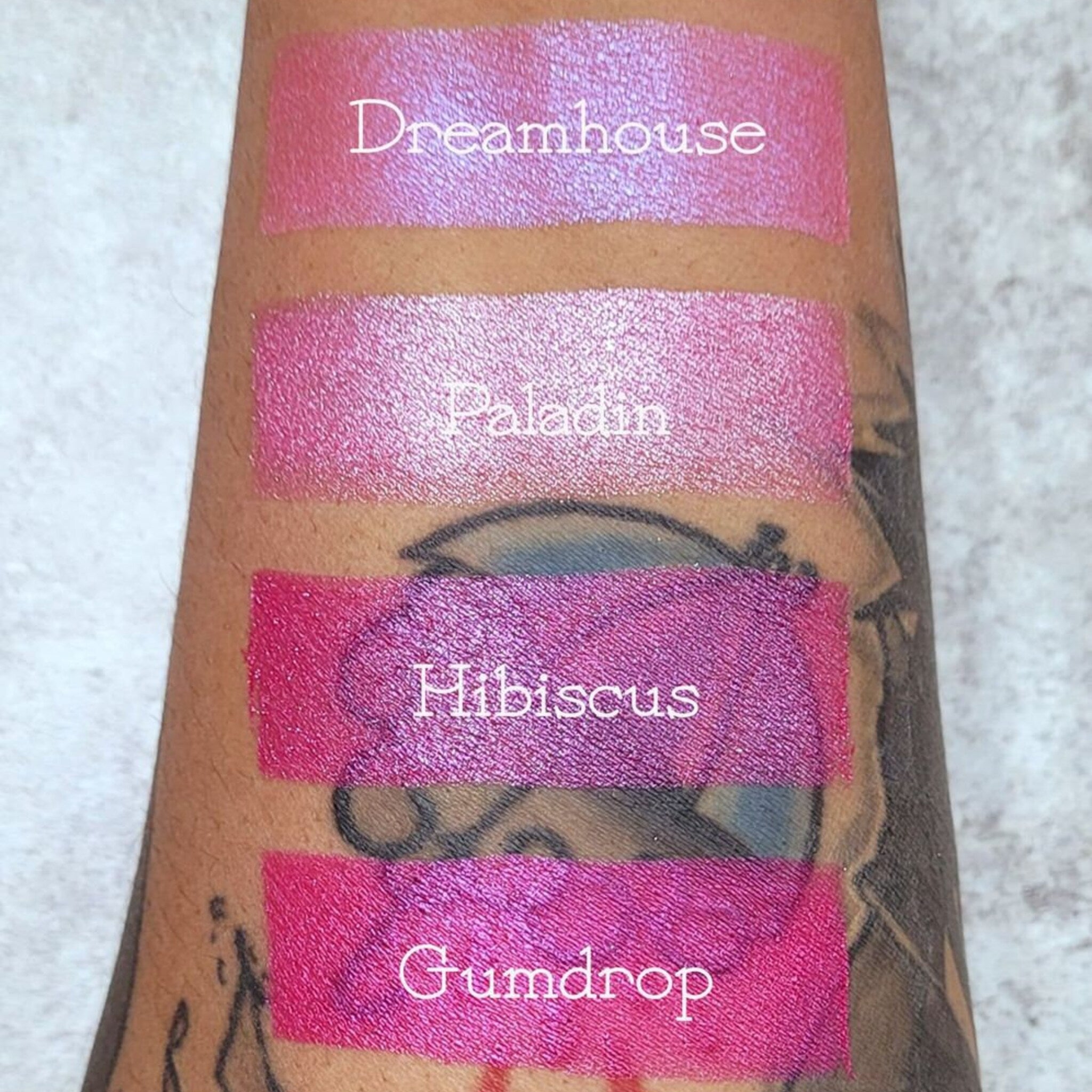 Close-up detail of vegan bubblegum pink pressed eyeshadow showing smooth matte texture and pigmented color payoff