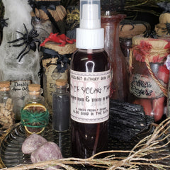 Toner bottle with dark red liquid, white spray top, and label with text, Halloween theme