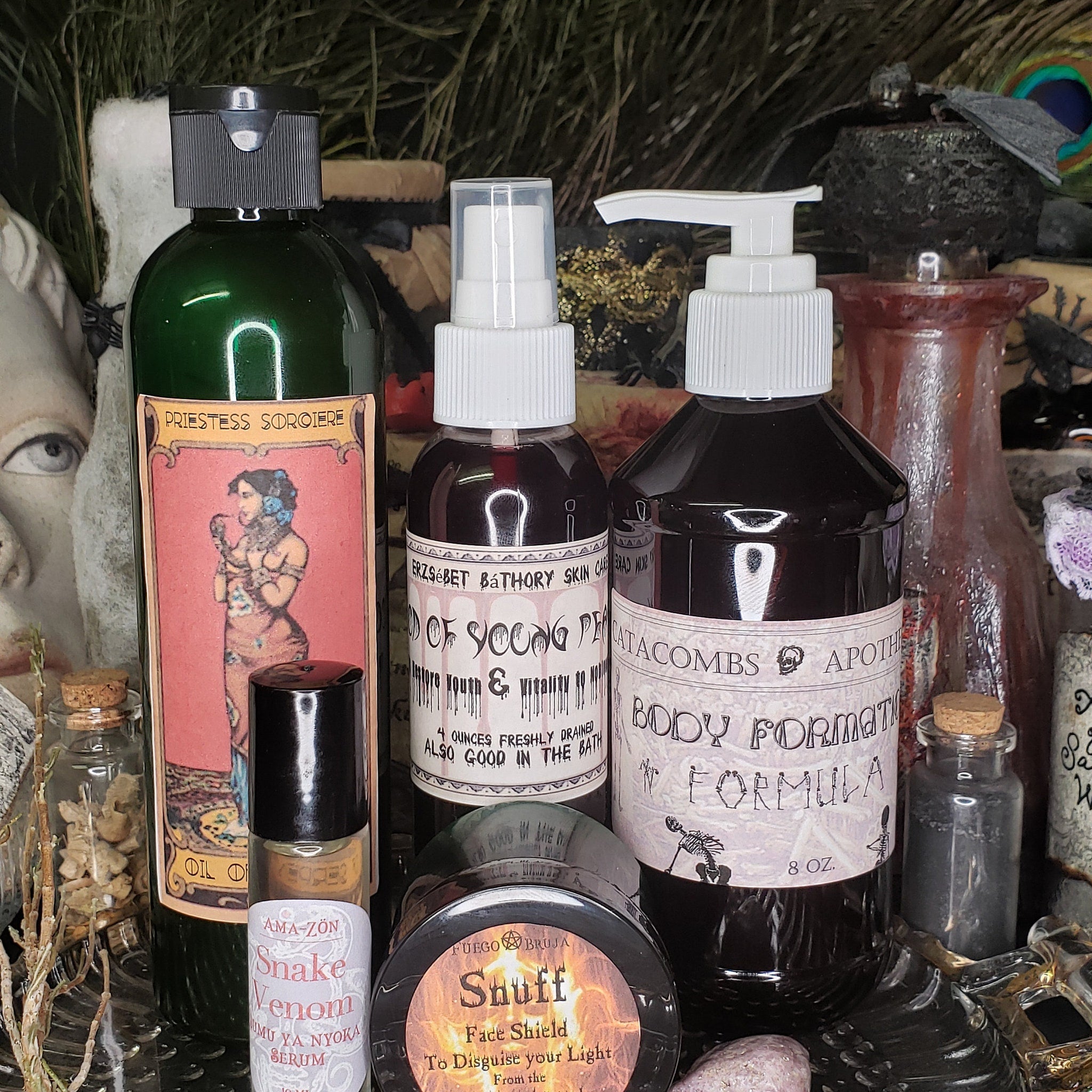 Bottles of various sizes and shapes, with dark liquid, white labels, and black caps, some with text
