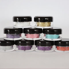 Hand applying iridescent white glitter eyeshadow with fingertip onto eyelid for shimmering effect