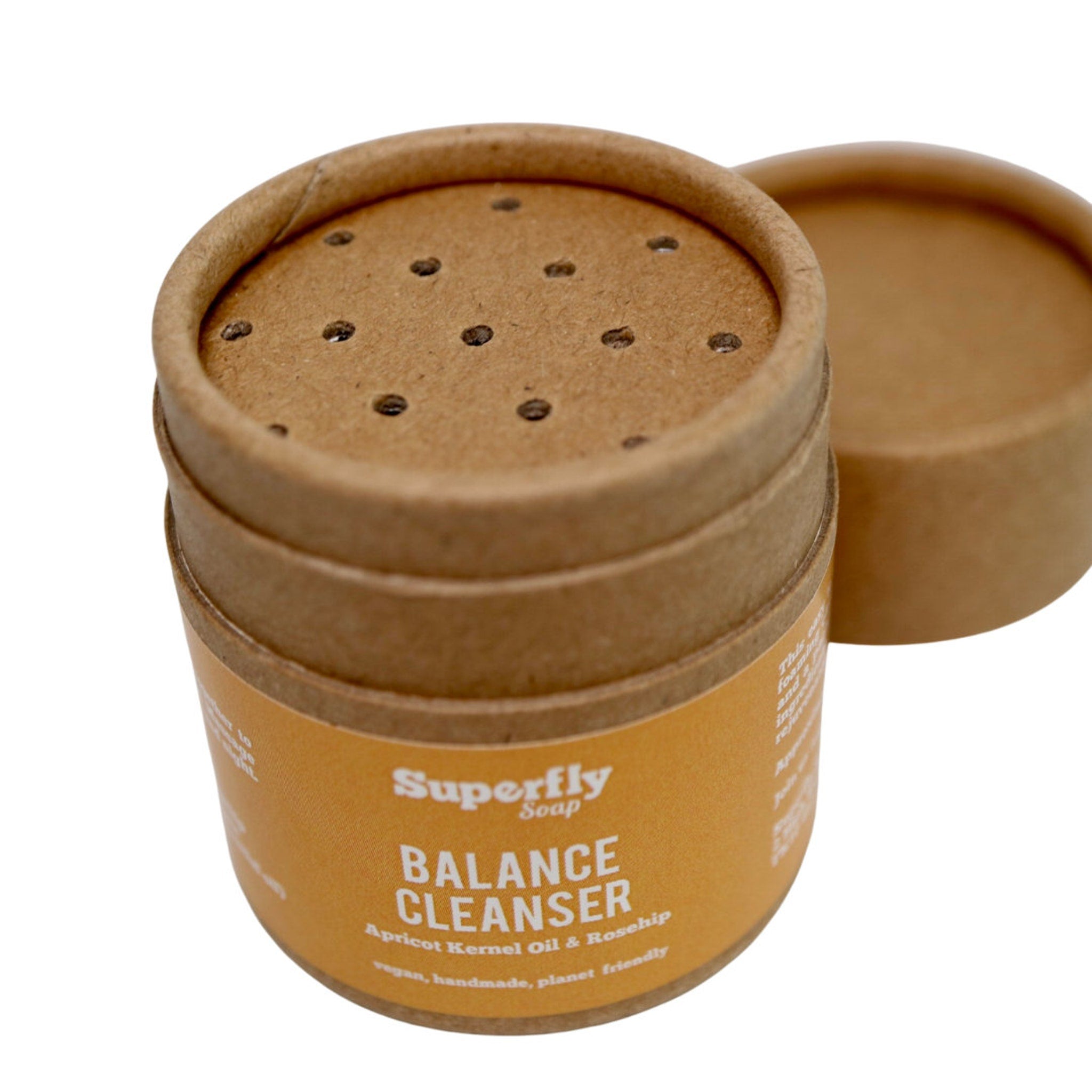Cleanser container made of brown cardboard with Superfly Soap label and perforated lid.