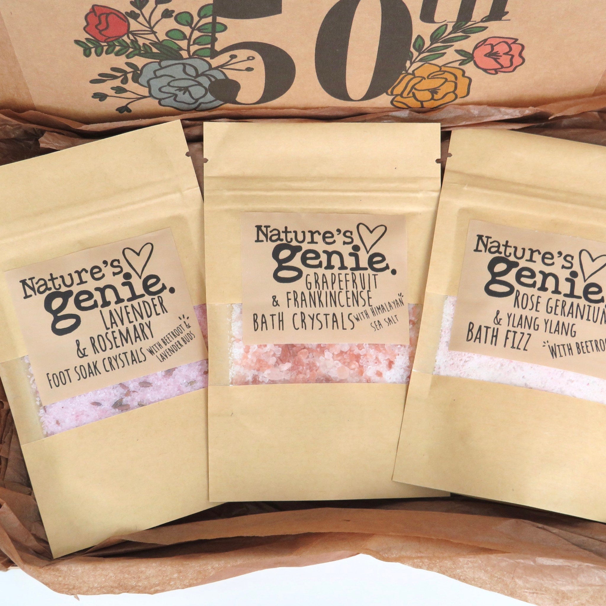 Bath crystals in kraft paper pouches, Nature's Genie brand, with pink, white, and brown contents