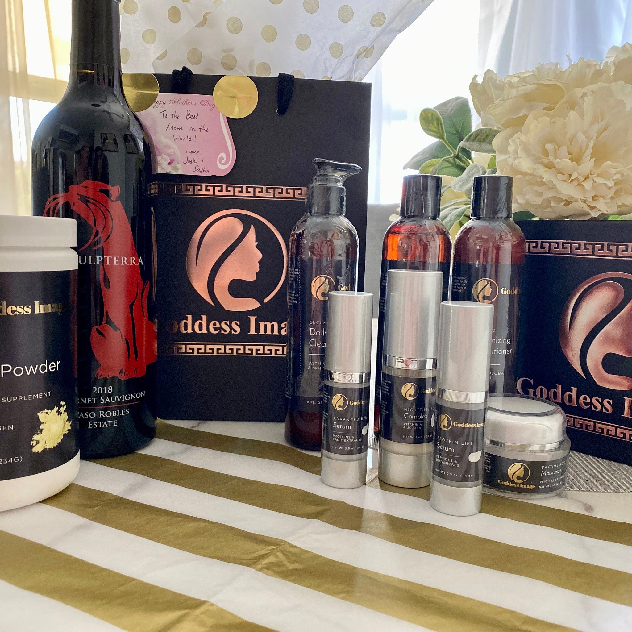 Skincare products with silver and black packaging on striped gold and white surface