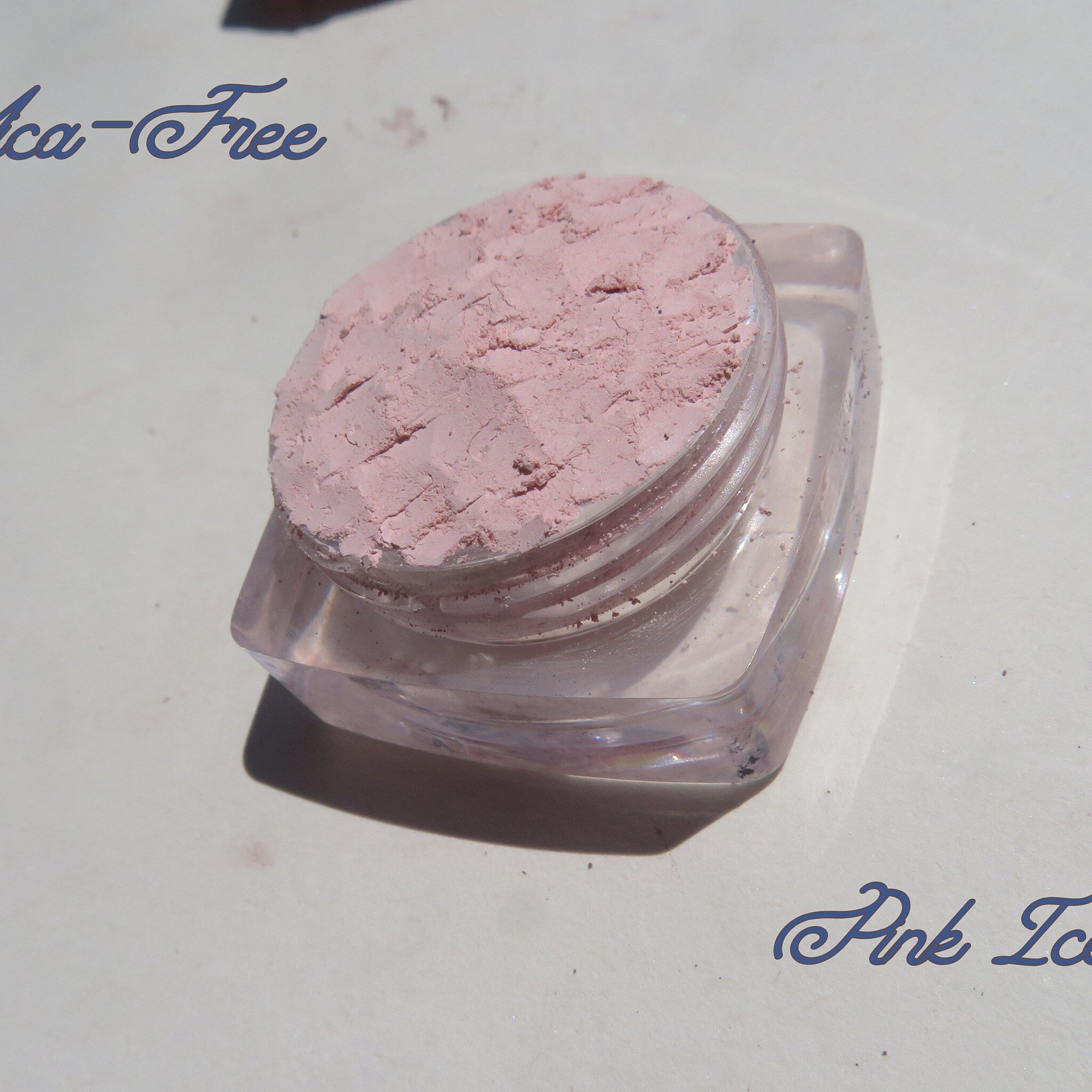 Close-up of three matte loose mineral eyeshadows in earthy tones with fine mica texture, cruelty-free vegan makeup