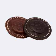 Leather discs, brown and black, stitched edge, Nurmagnus logo visible