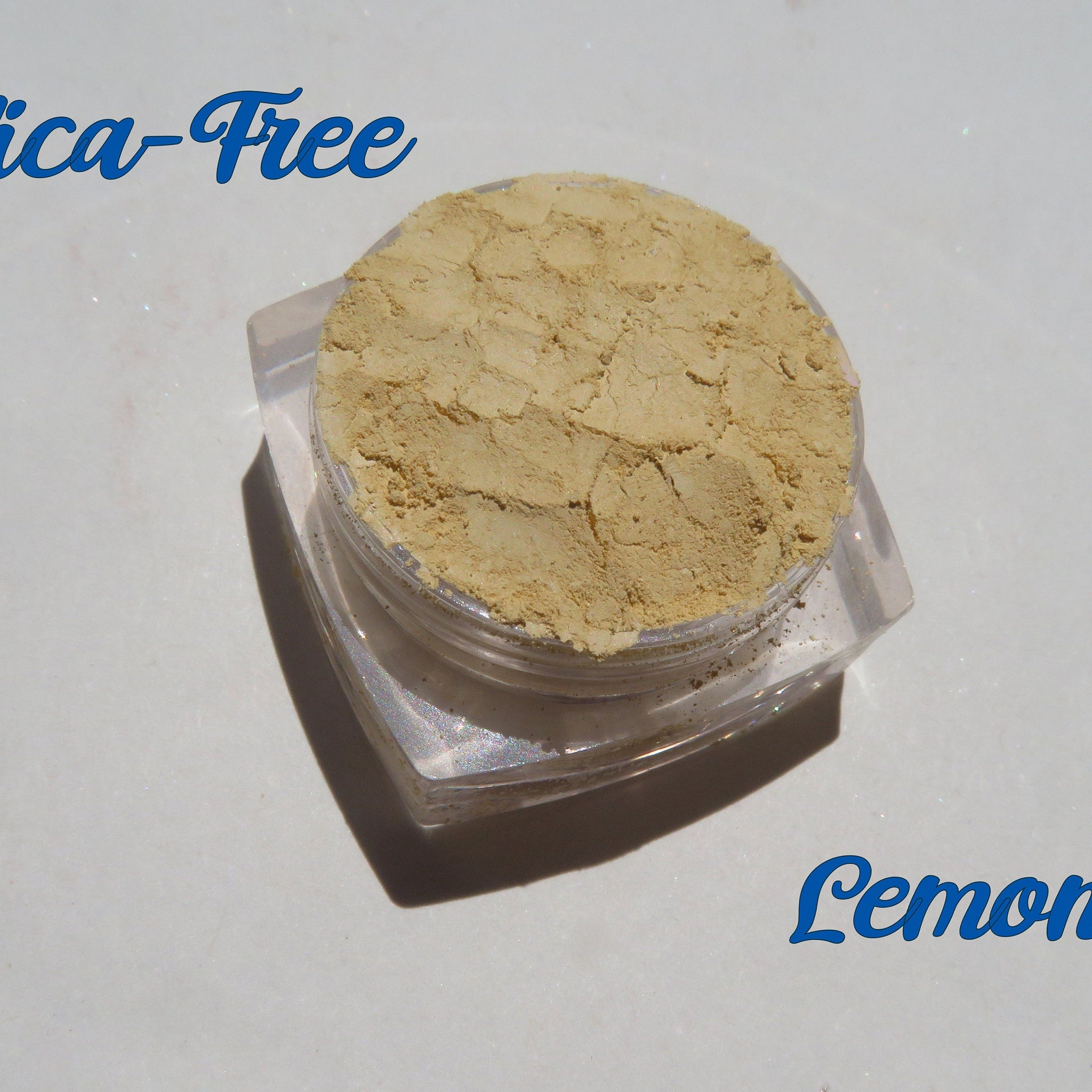Bright yellow matte loose mineral eyeshadow in a small round jar with black lid, vegan and cruelty-free.