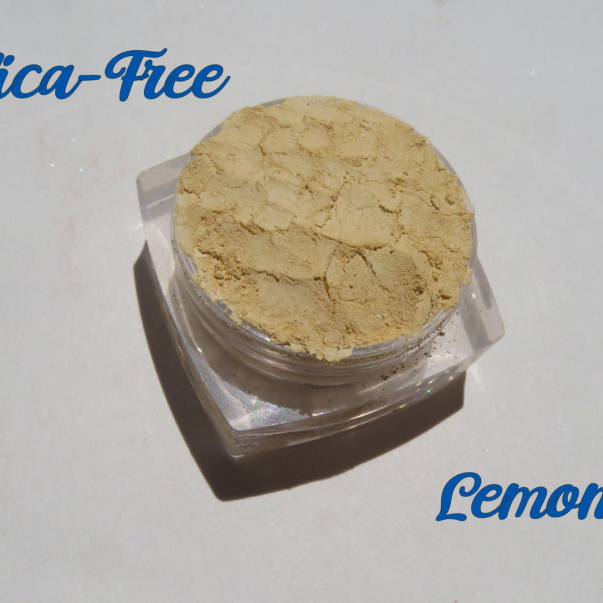Bright yellow matte loose mineral eyeshadow in a small round jar with black lid, vegan and cruelty-free.