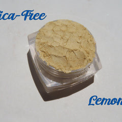 Bright yellow matte loose mineral eyeshadow in a small round jar with black lid, vegan and cruelty-free.