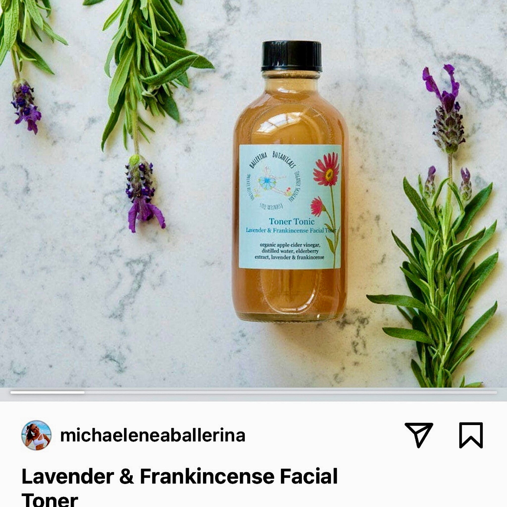 Facial toner bottle with brown liquid, black cap, and Ballerina Botanicals label, with lavender and green sprigs around it