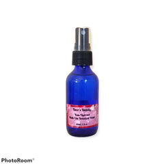 Rose hydrosol spray bottle, blue glass bottle with black spray top, Bear's Beauty label visible