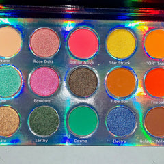 Close-up of Galactic Astronomy palette showing shimmering navy and silver eyeshadows with star-pressed designs
